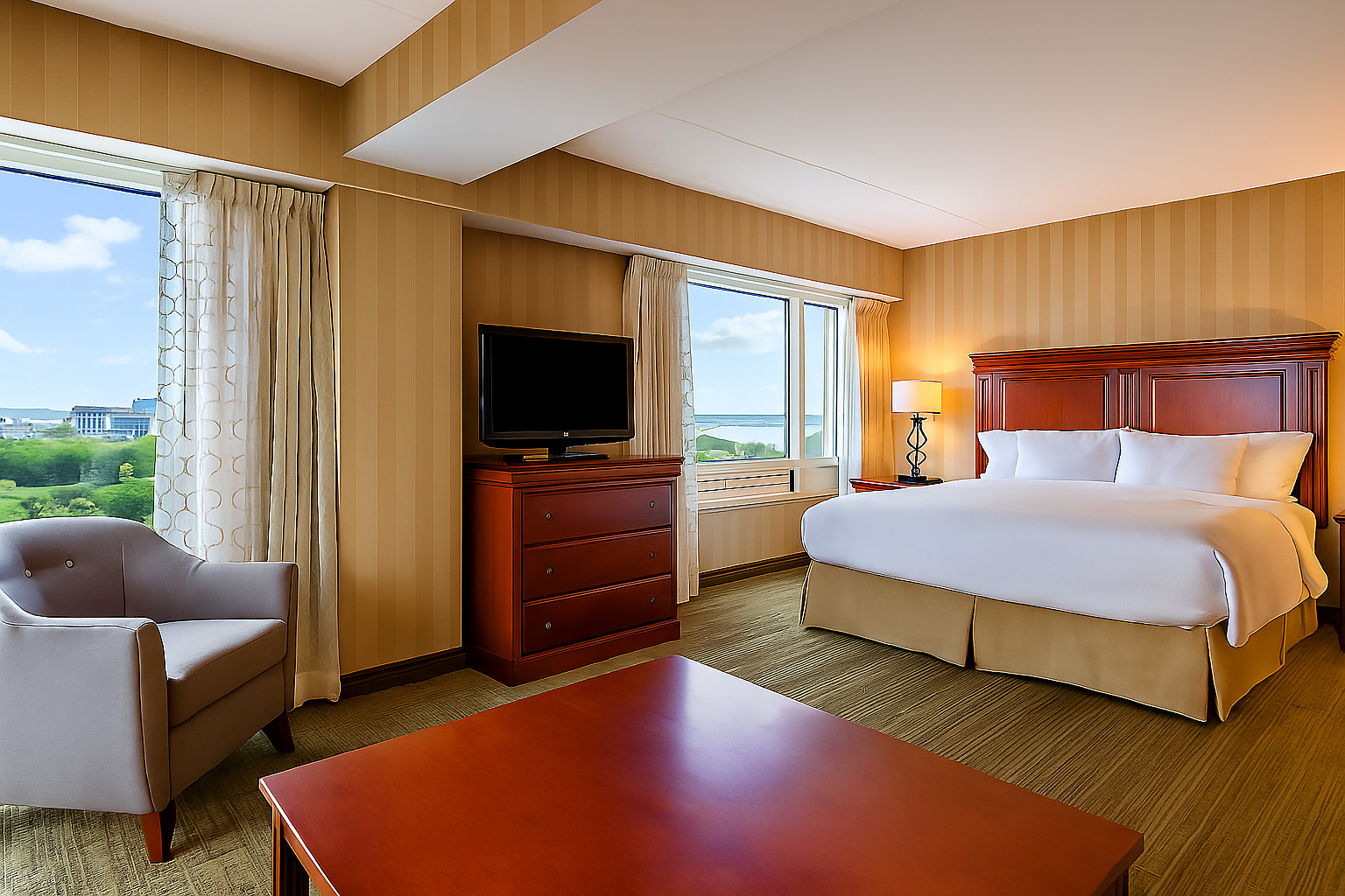 Corner king guest suite with dual windows and city and river outlook