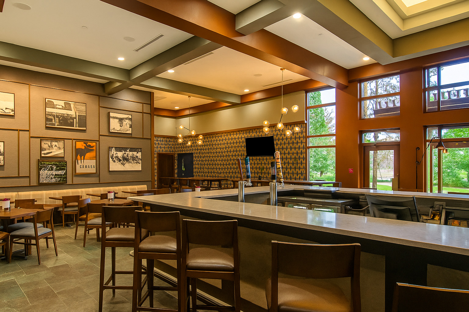 Contemporary lounge bar with high ceilings and patterned feature wall