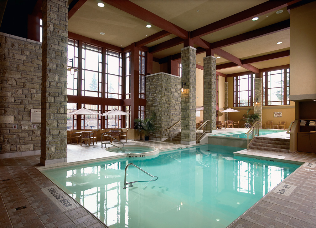 Indoor saltwater pool and whirlpool area with stone columns