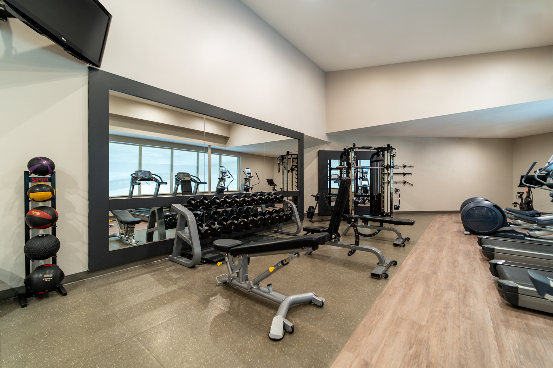 Modern hotel fitness centre with free weights and cardio equipment