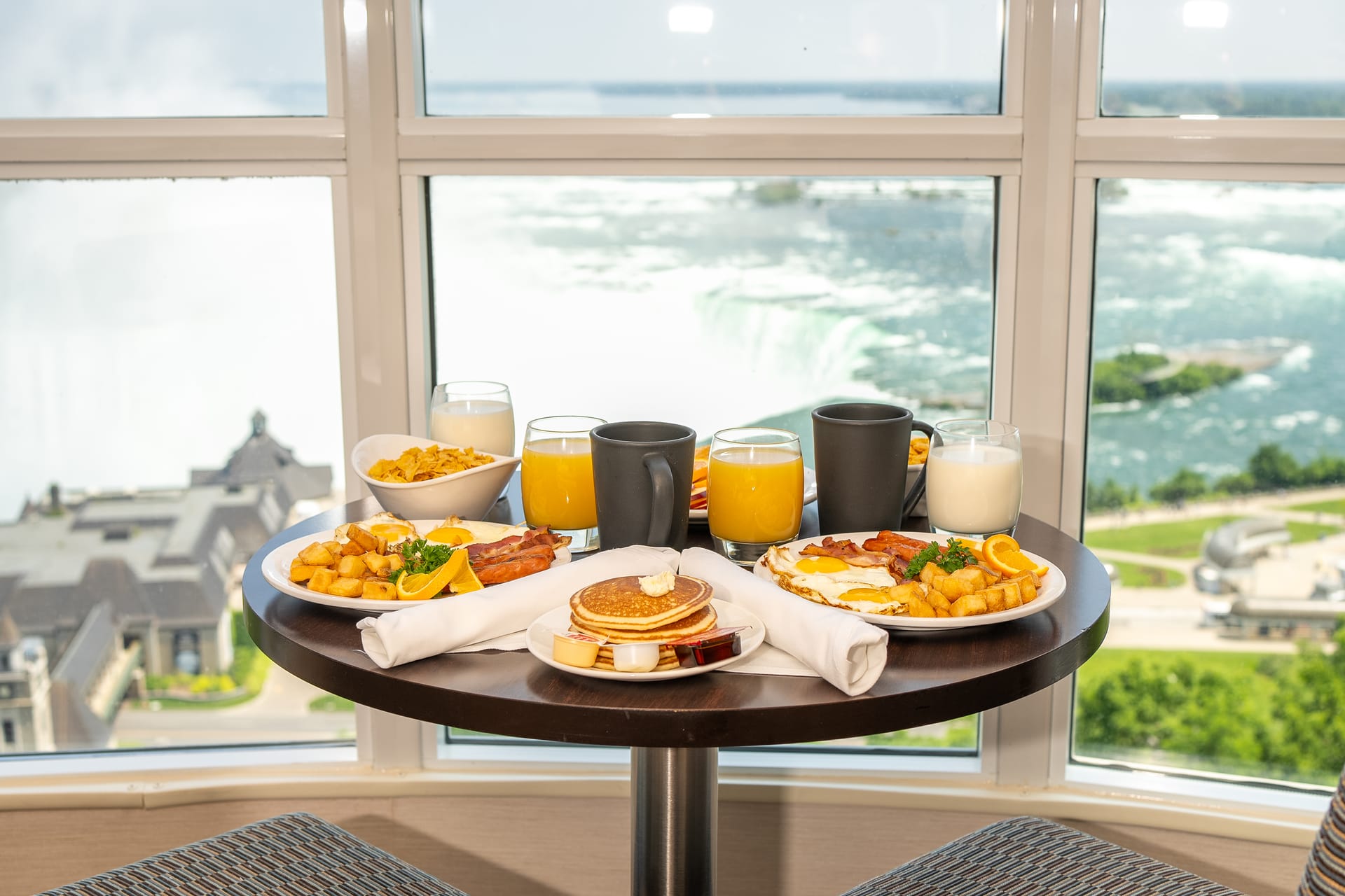 Breakfast service set in front of a falls-facing window