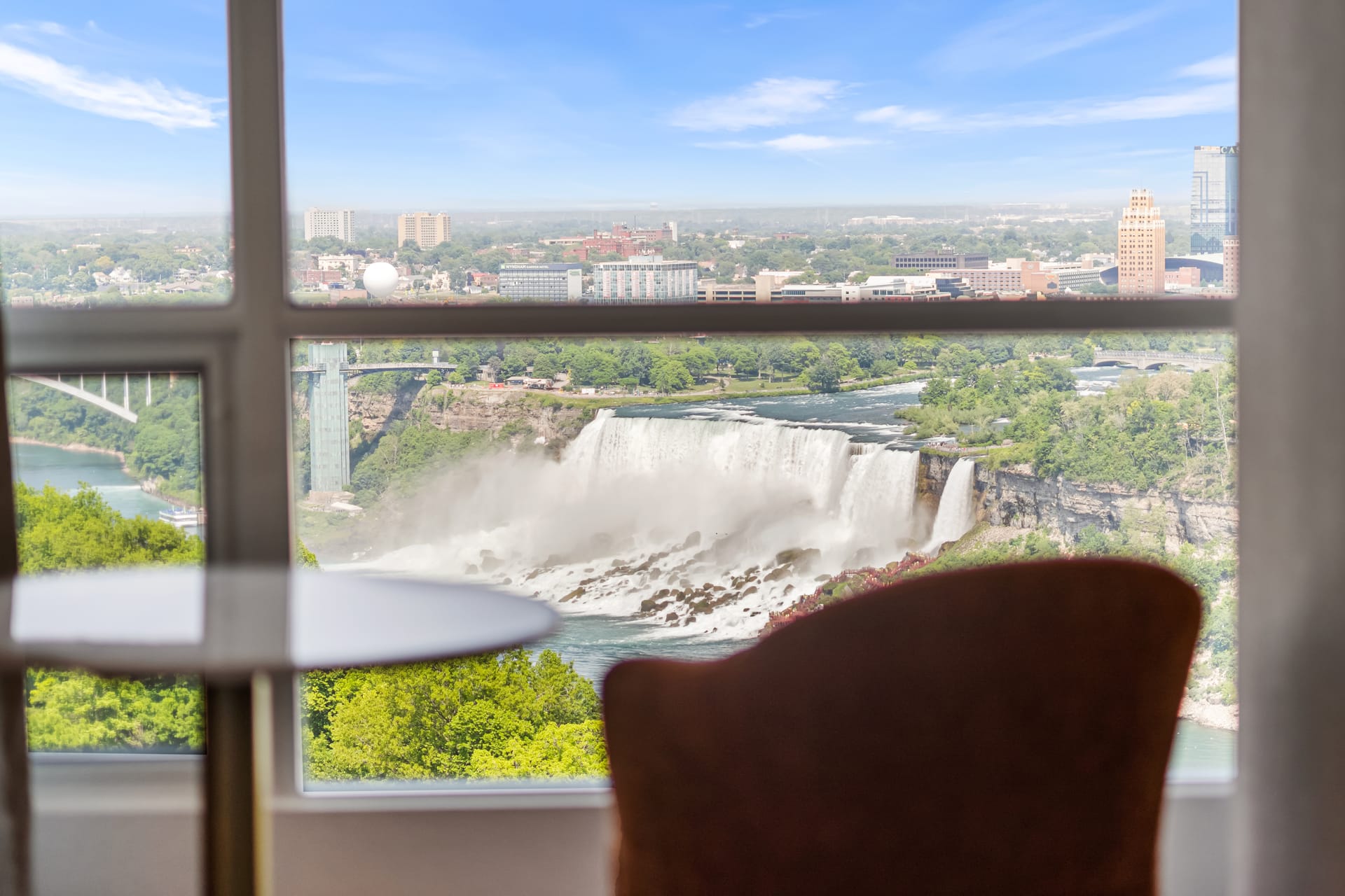 American Falls seen through a suite window with lounge chair in foreground