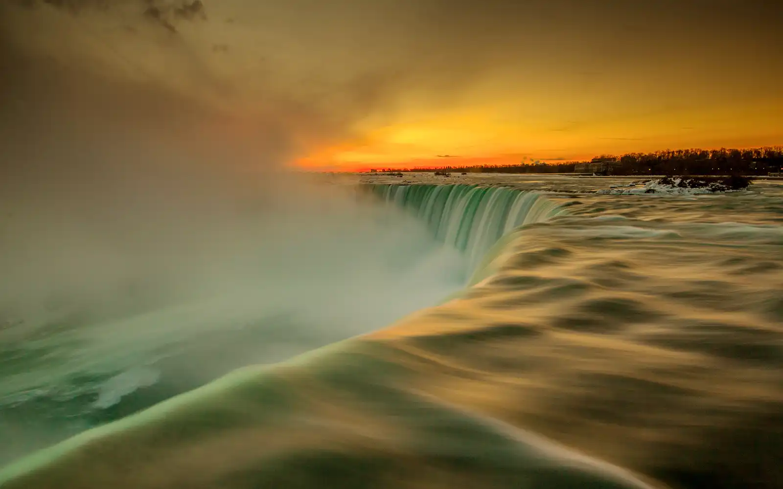Close-up view of Niagara Falls water and evening sky