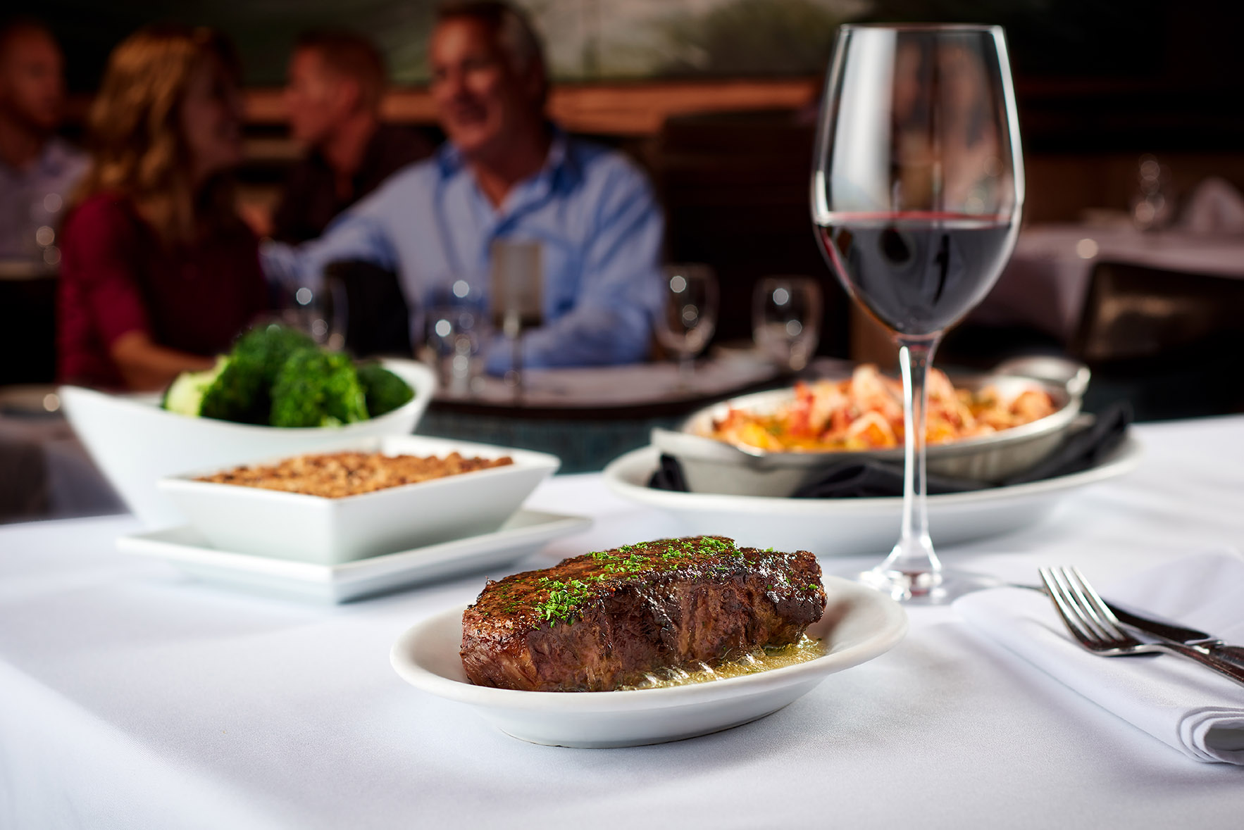 Steak and seafood table presentation in an upscale dining setting